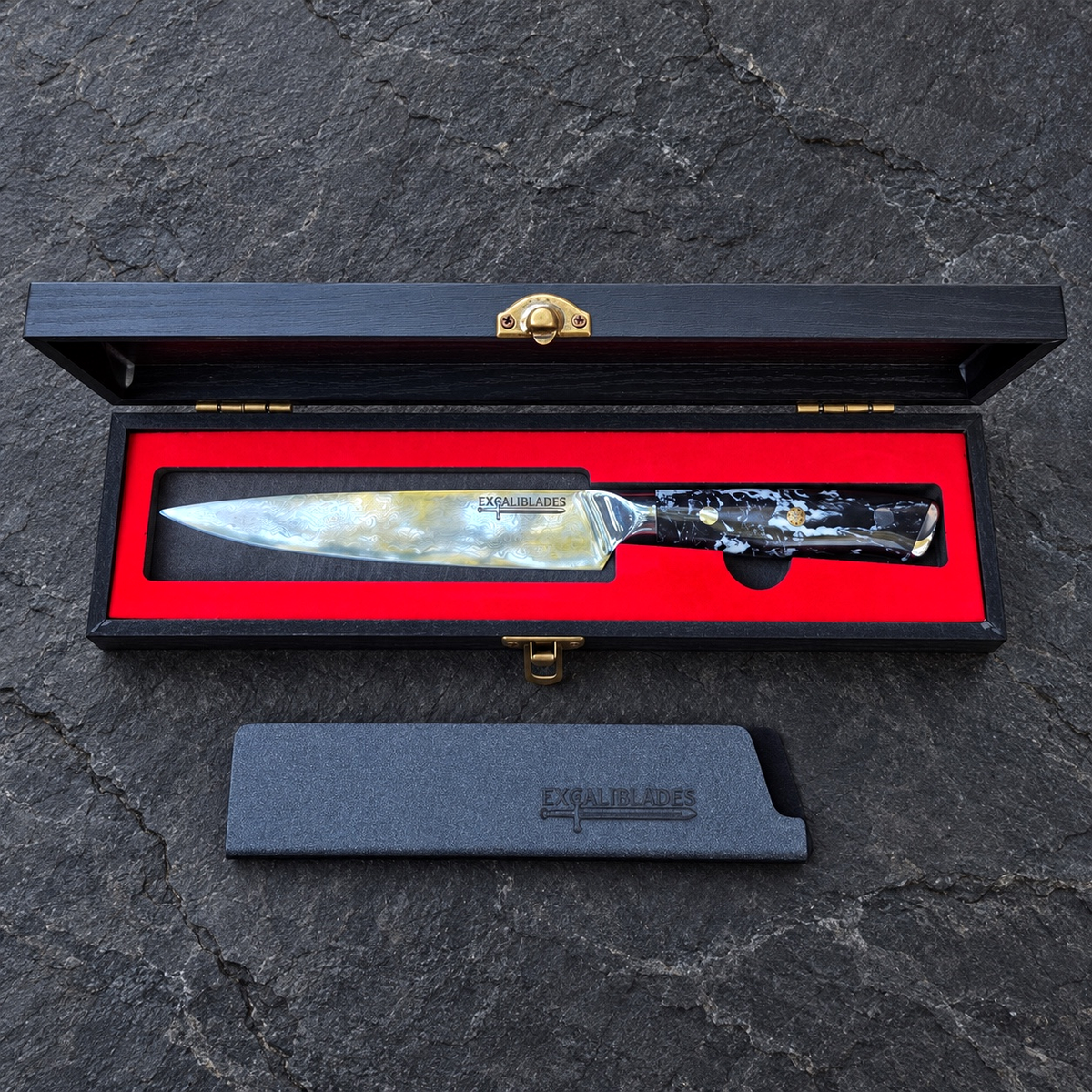 Excaliblades utility knife inside its open red-lined black wooden gift box with protective sheath