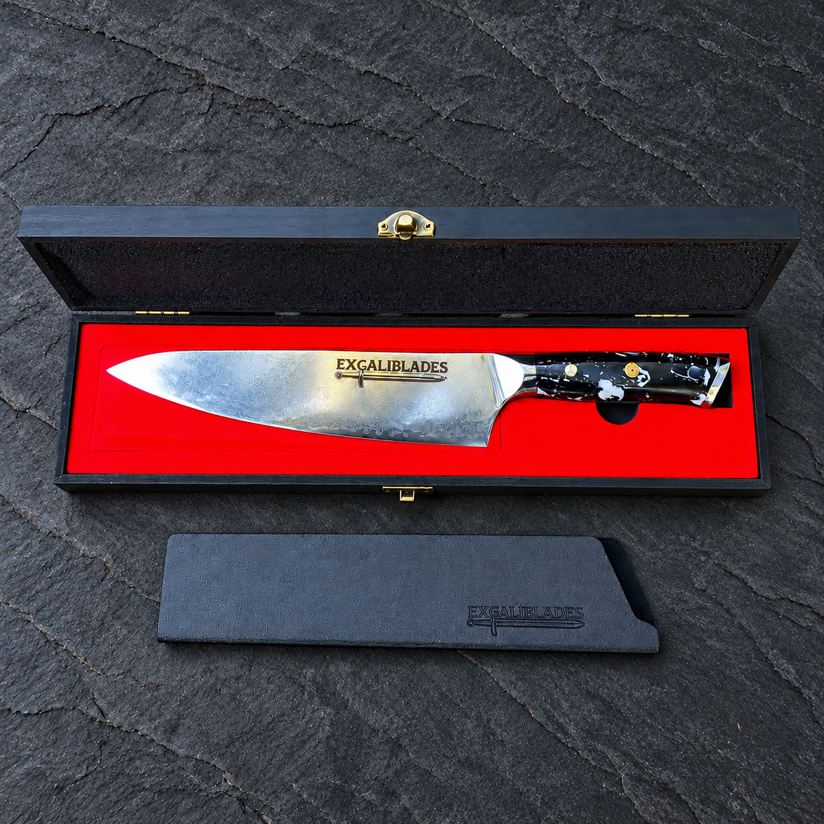 Excaliblades chef knife inside its open red-lined black wooden gift box with protective sheath